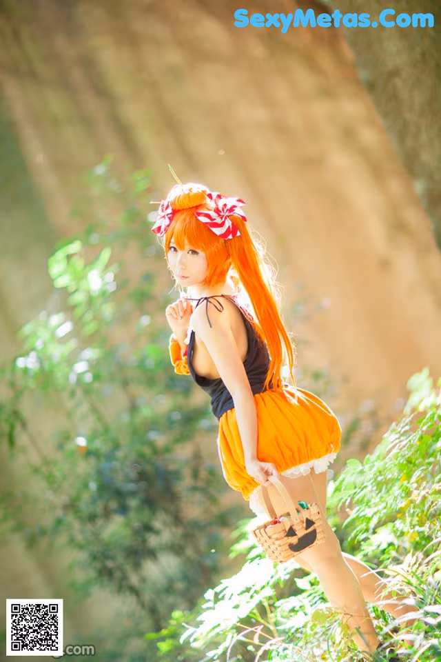 A woman in an orange dress holding a basket in the woods.