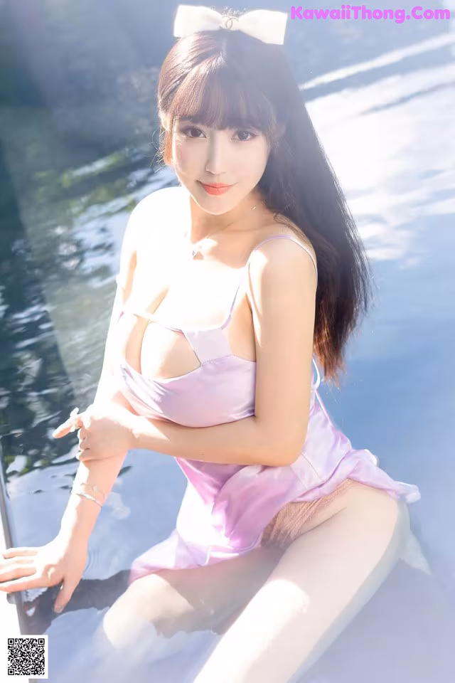 A woman in a pink dress sitting on a boat.