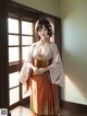 A woman in a kimono standing in front of a window.