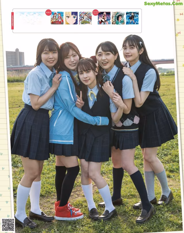 A group of young women in school uniforms posing for a picture.